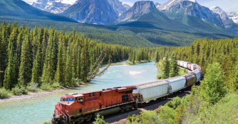 Freight Train moving along Bow River in the Canadian Rockies, Alberta, Canada